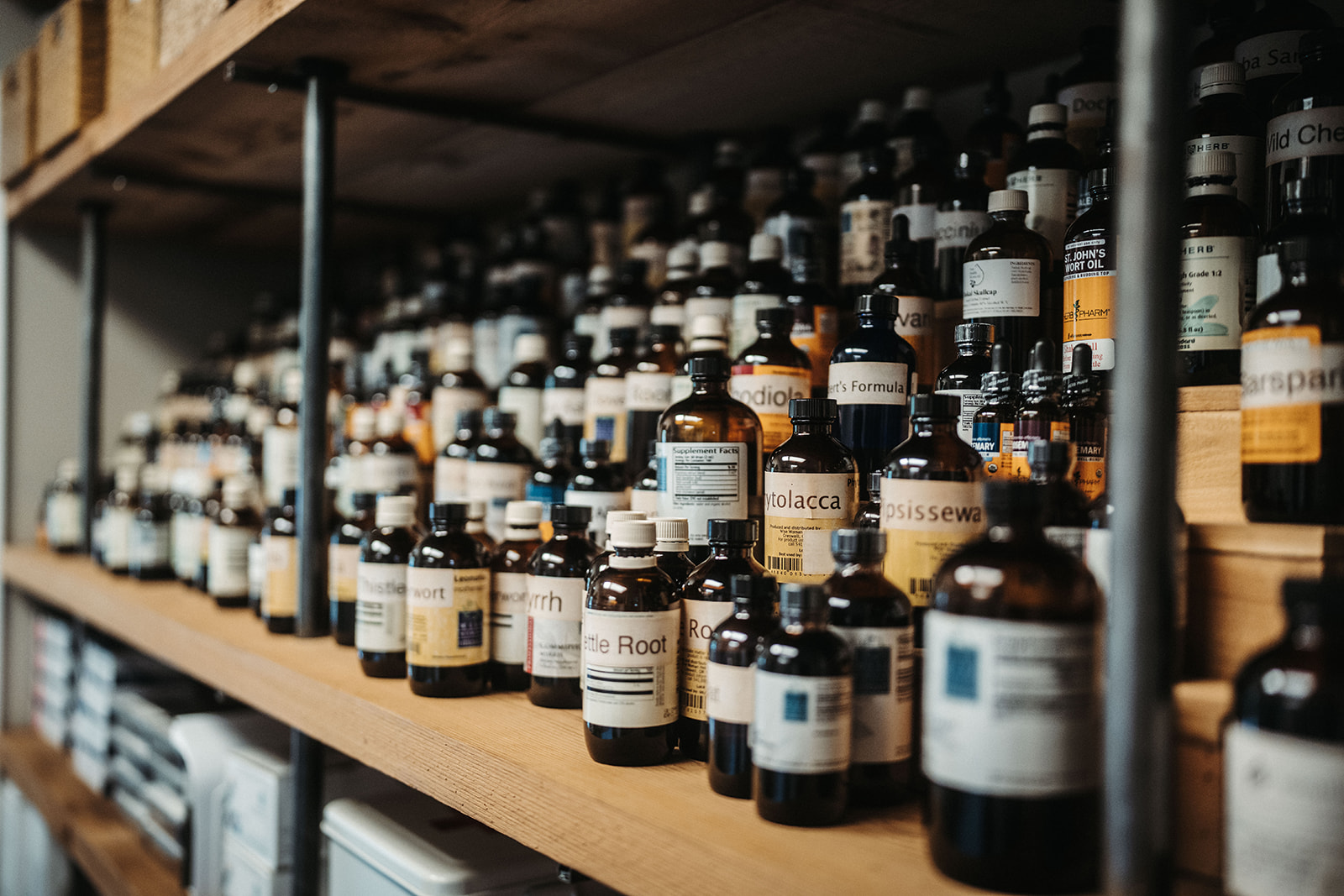 Shelves filled with NuHealth supplement and wellness product bottles.